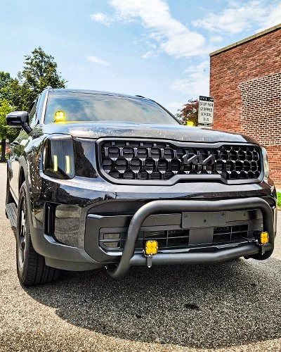 Kia Telluride with amber auxiliary lights and bumper guard